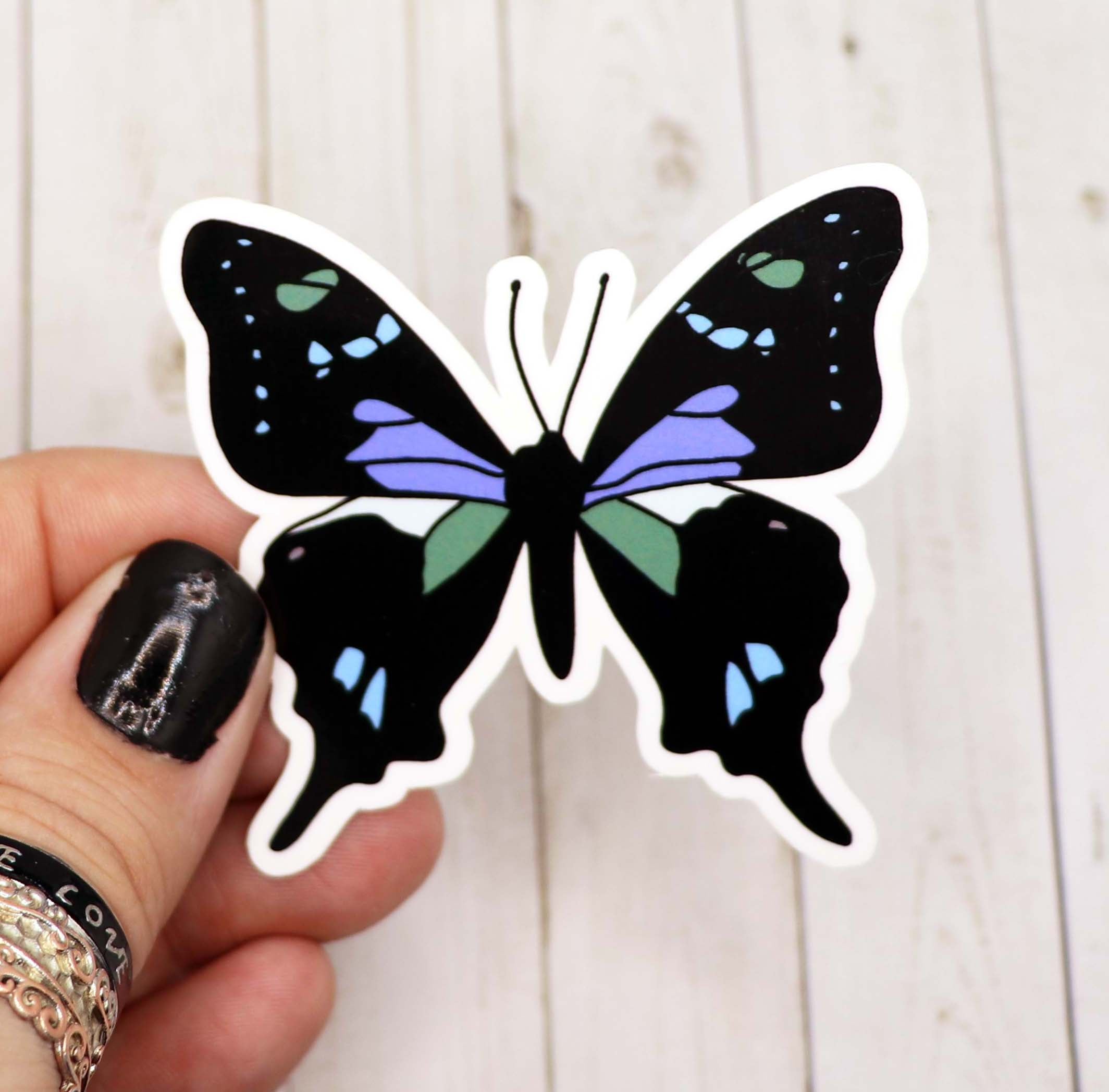 A vibrant blue and green butterfly sticker on a white background, showcasing intricate details and a matte finish.