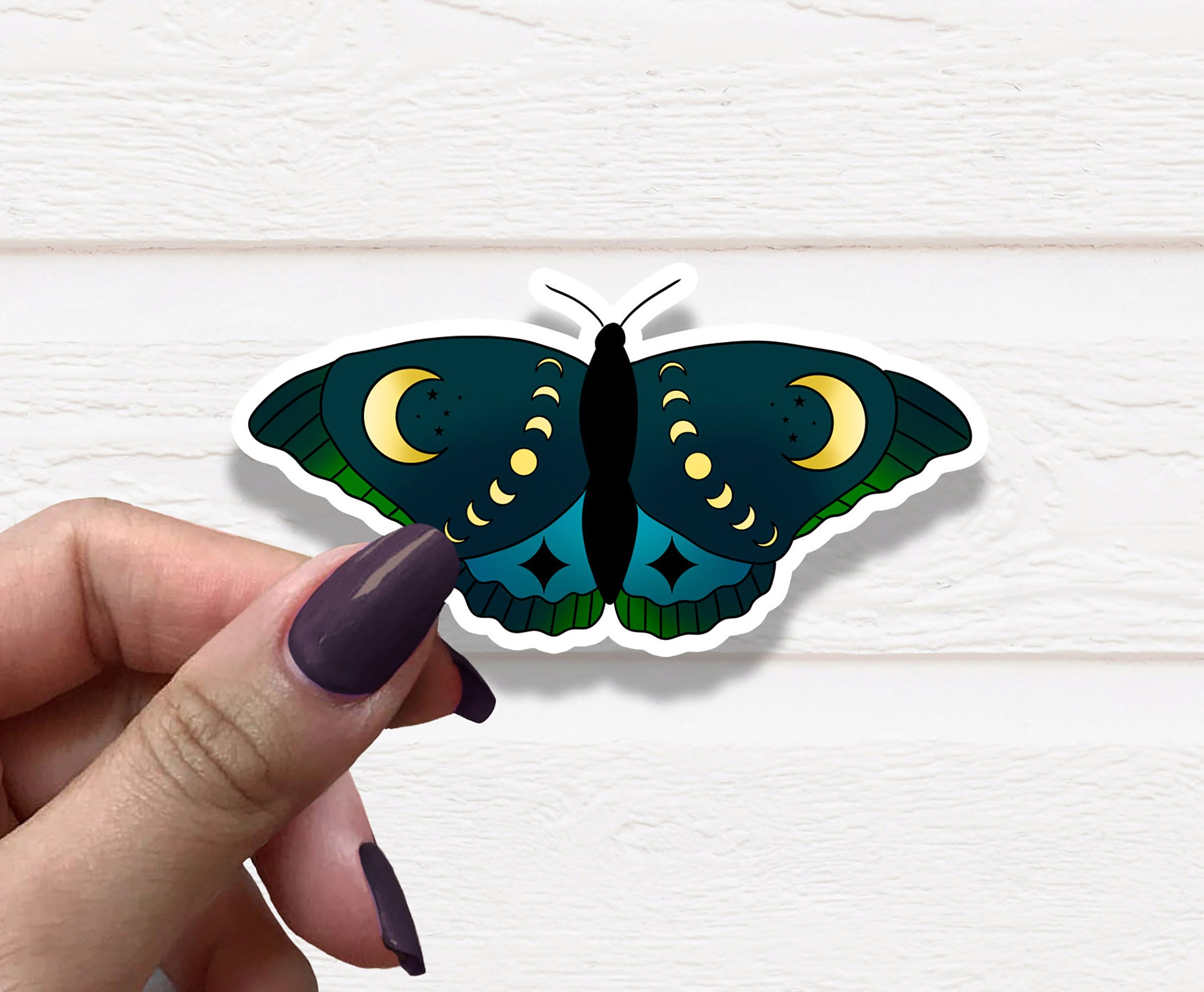 A vibrant blue moth vinyl sticker on a white background, showcasing intricate details and colors.