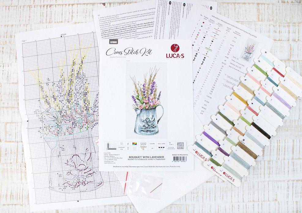 A counted cross-stitch kit featuring a bouquet of lavender and roses in a watering can, showcasing vibrant colors and intricate design.