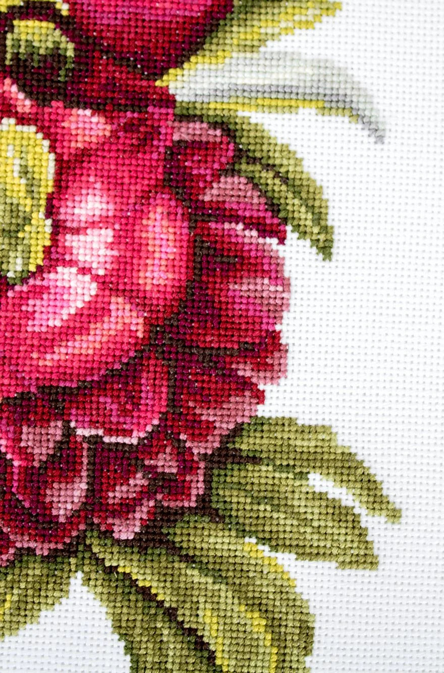 A counted cross-stitch kit featuring a beautiful peony bouquet design, including canvas, colorful threads, needle, and instructions.