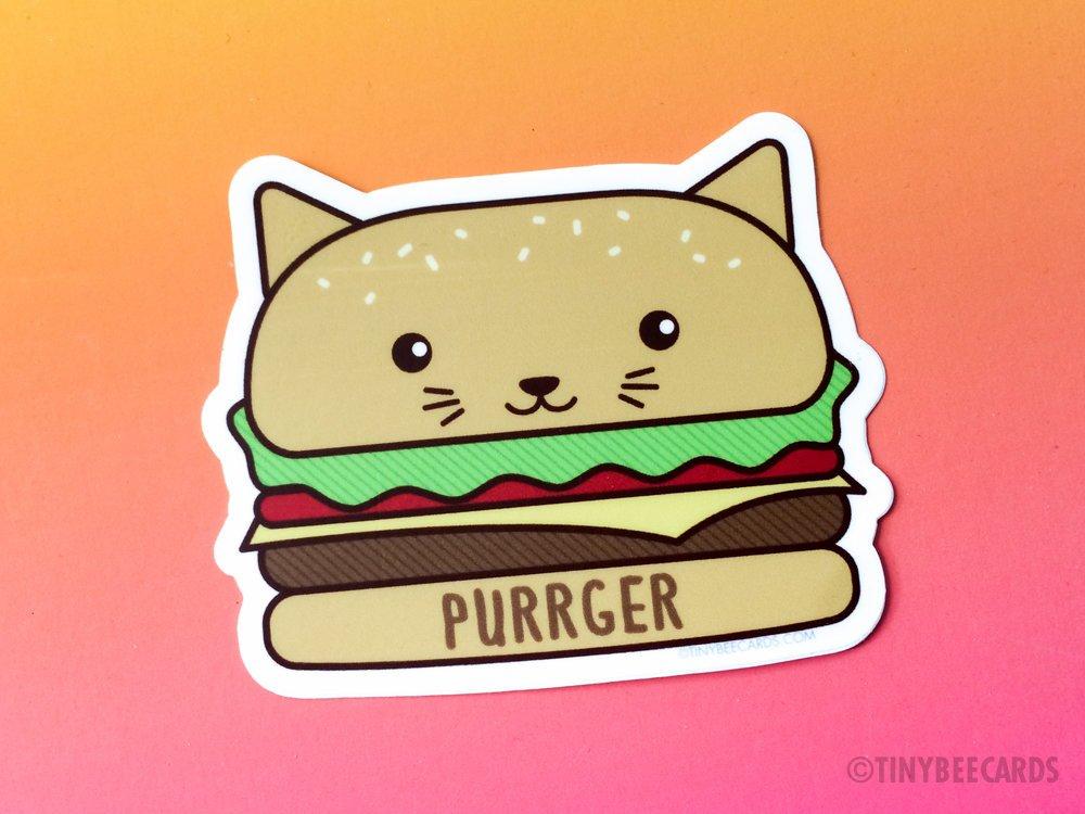 A cute vinyl sticker featuring a cat designed as a cheeseburger with the text 'Purrger'.