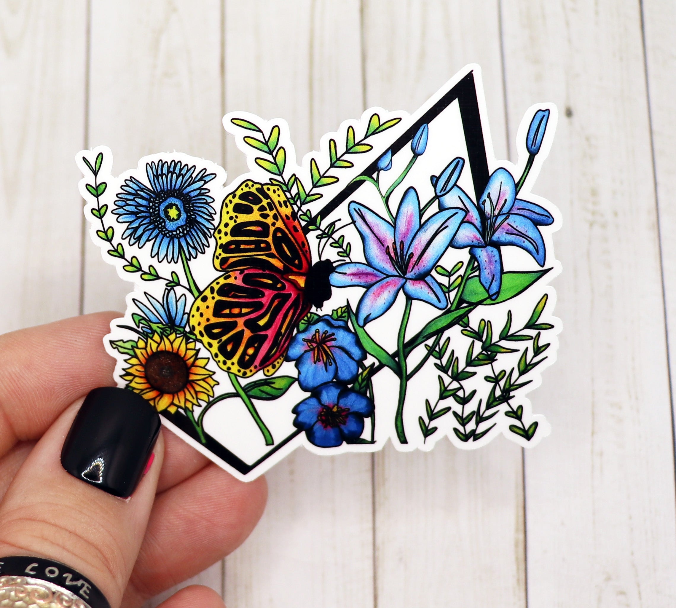 A vibrant butterfly sticker on a white background, showcasing intricate details and colors.