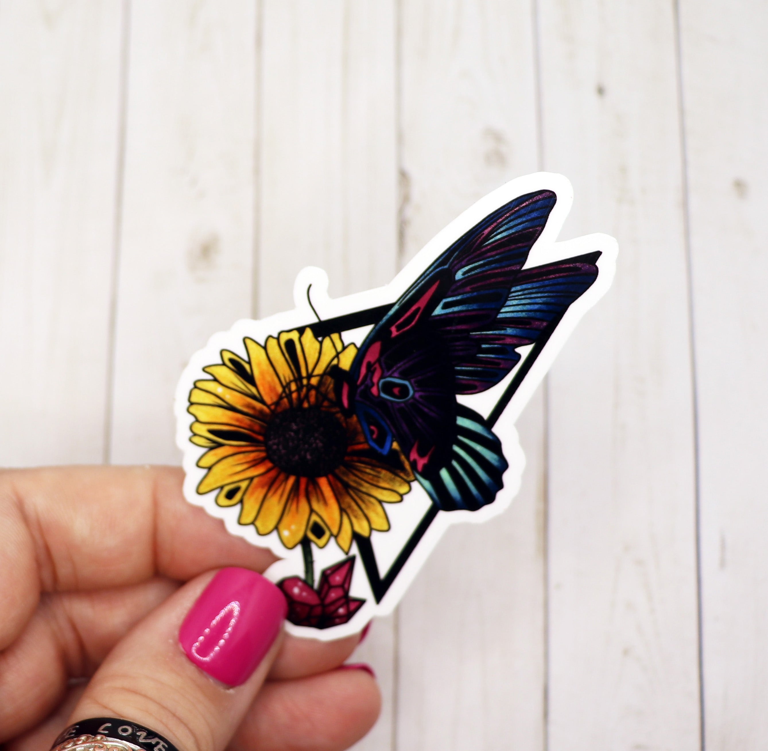 A vibrant butterfly sticker on a matte vinyl surface, showcasing intricate details and colors.