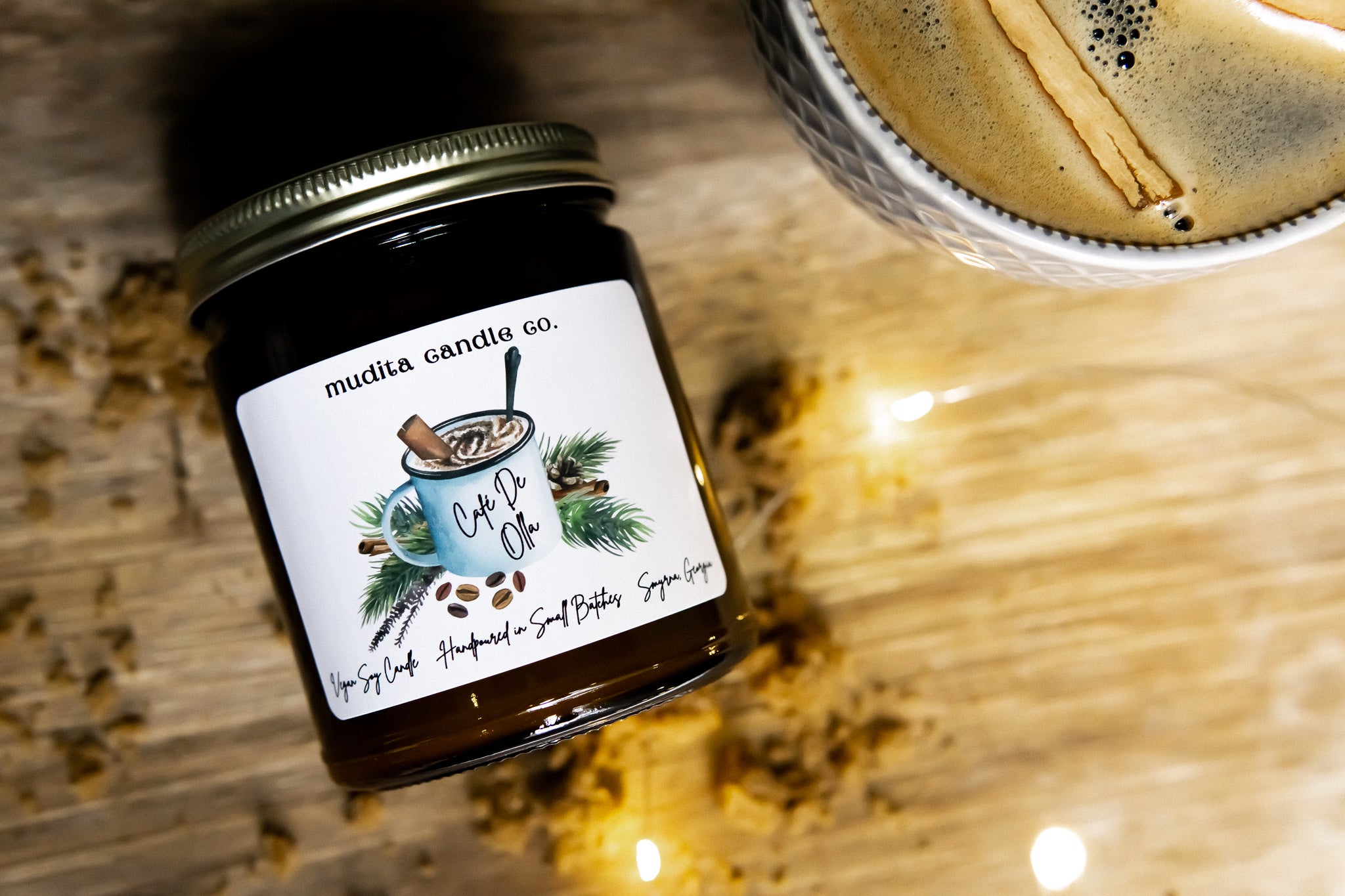 Cafe De Olla candle in an amber glass jar with a gold lid, showcasing roasted coffee beans, vanilla, and cinnamon fragrance.