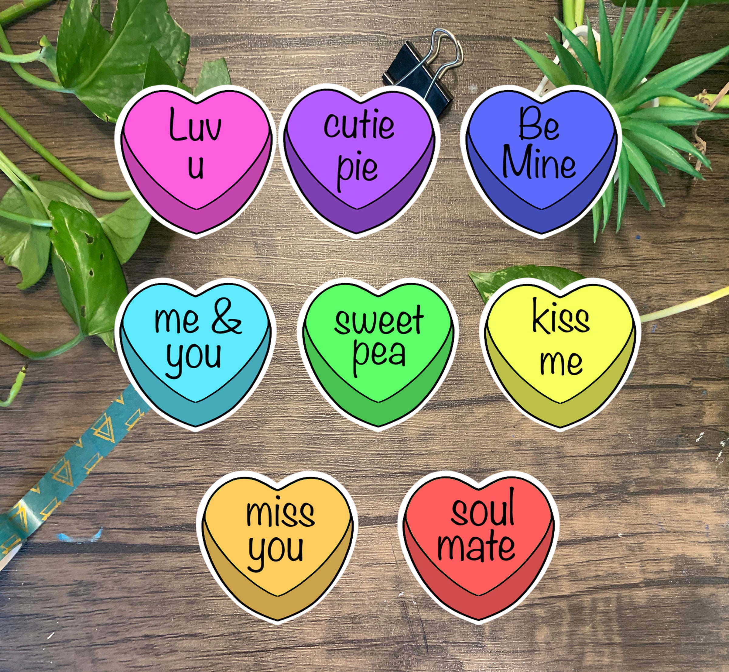 A colorful pack of 8 candy heart stickers, each measuring 2x2 inches, featuring vibrant designs perfect for personalizing items.