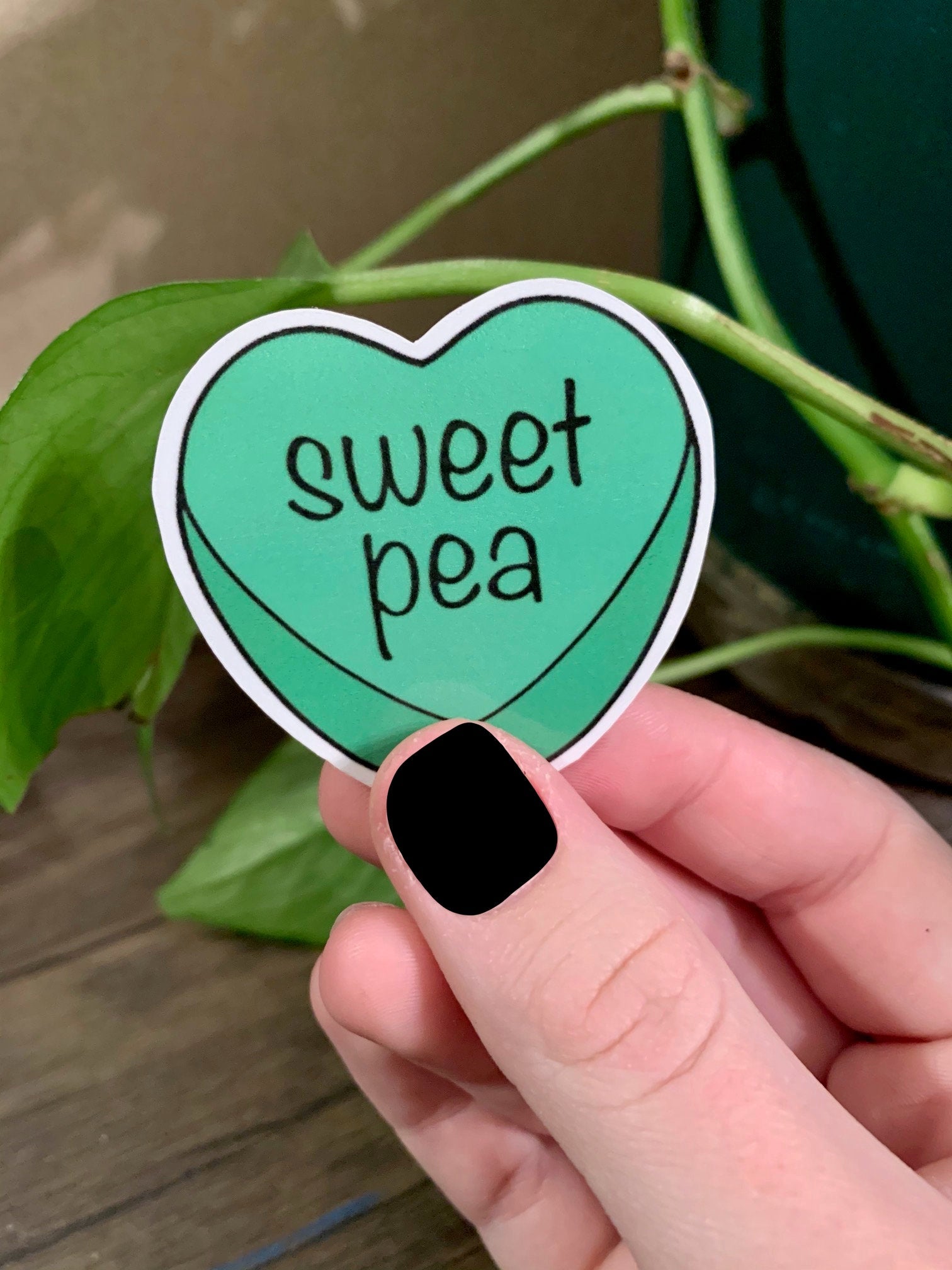 A colorful pack of 8 candy heart stickers, each measuring 2x2 inches, featuring vibrant designs perfect for personalizing items.