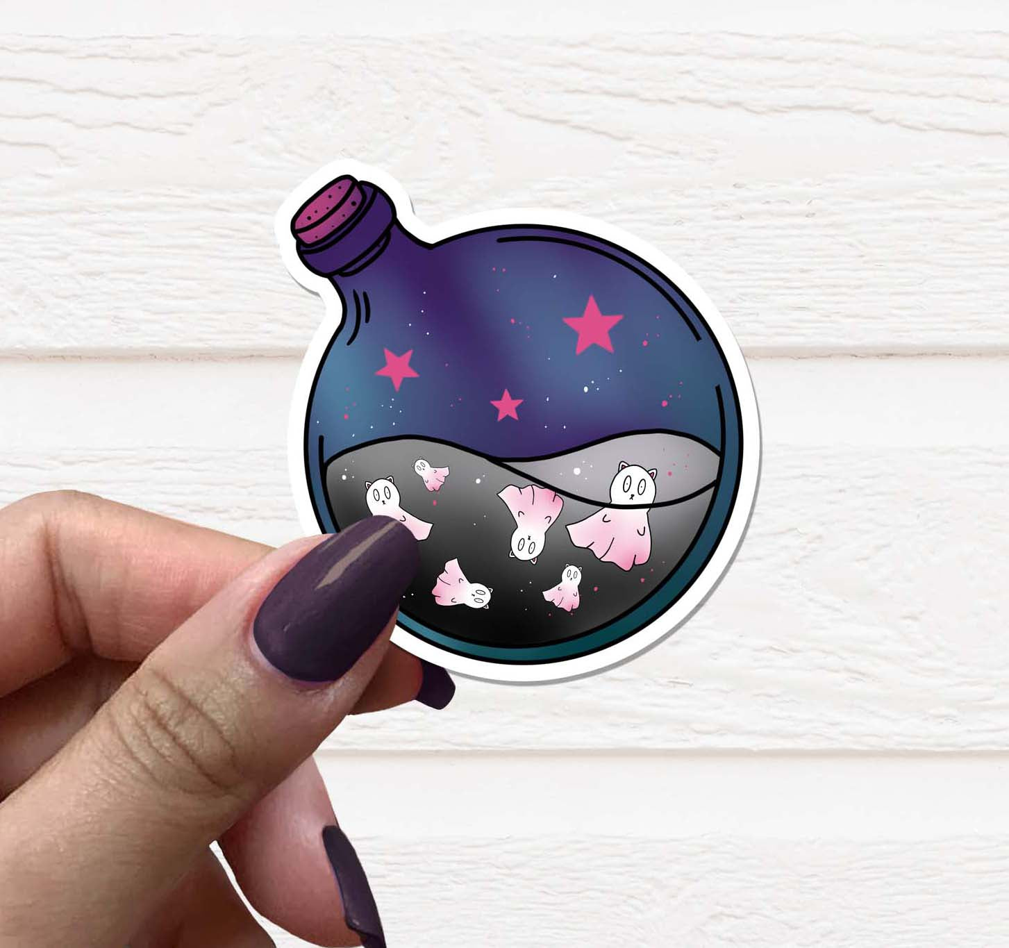 A whimsical Cat Ghost Potion Bottle Vinyl Sticker featuring a playful cat design with potion elements.