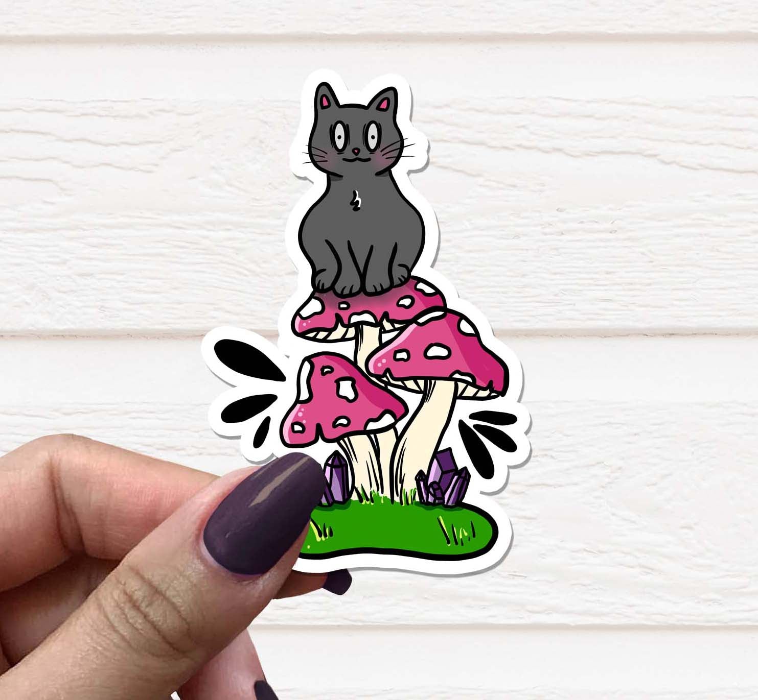 A colorful vinyl sticker featuring a whimsical cat sitting on a mushroom, perfect for personalizing various items.