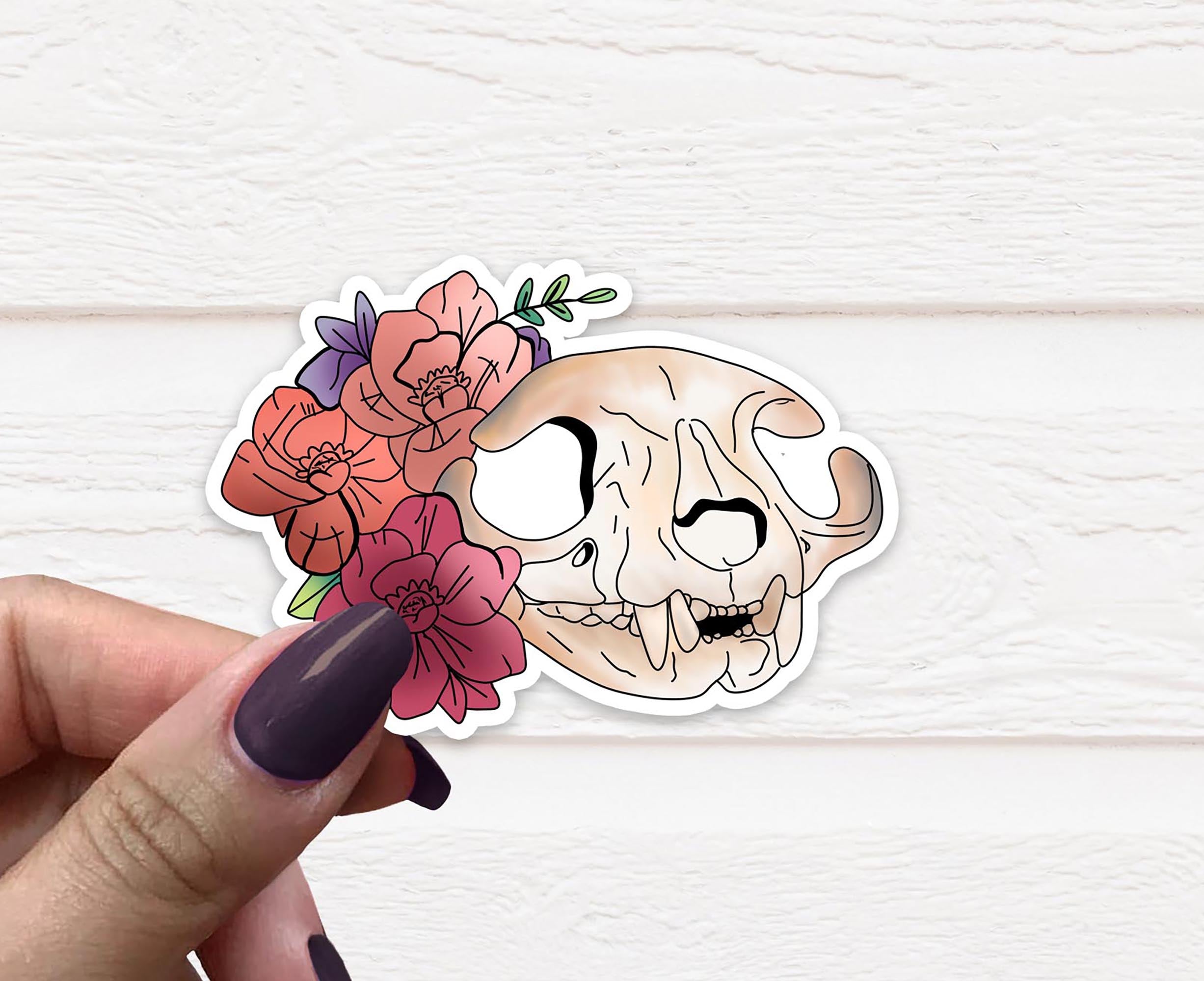 A detailed Cat Skull Vinyl Sticker on a white background, showcasing intricate designs and a matte finish.