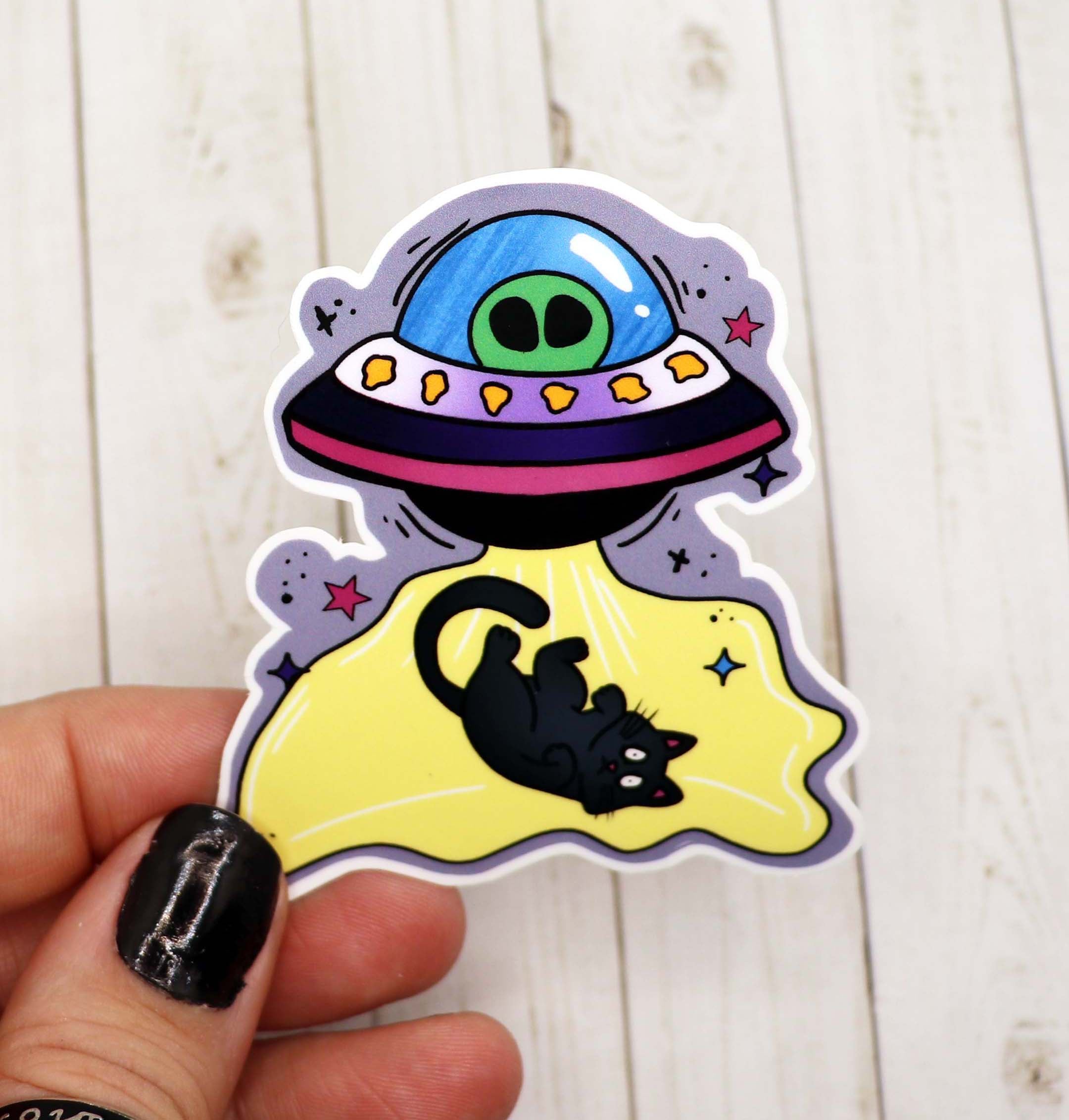 A colorful Cat UFO Sticker featuring a whimsical cat in a UFO design, perfect for personalizing various items.