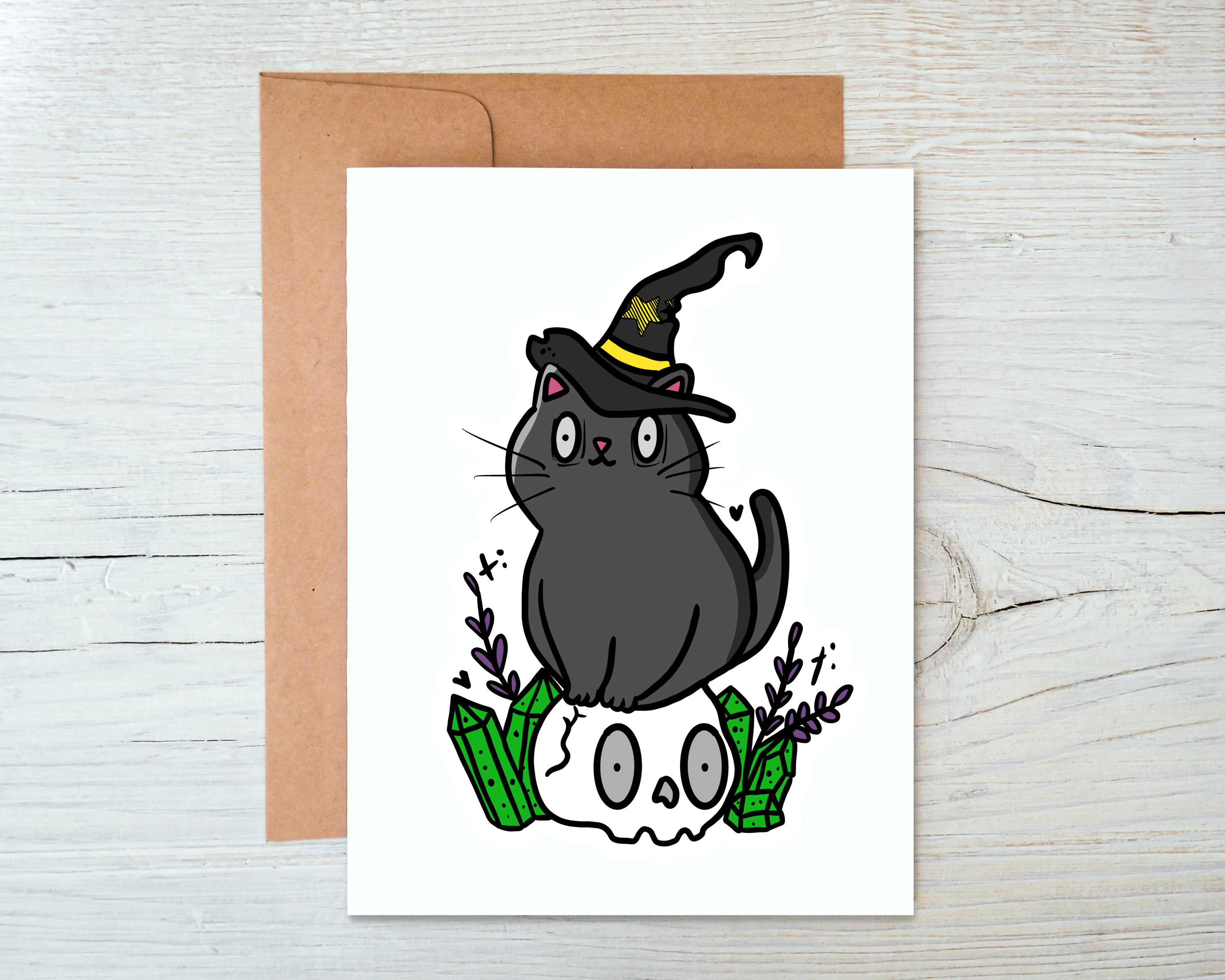 A whimsical Cat Witch Card featuring a playful cat in witch attire, blank inside, accompanied by a kraft envelope.