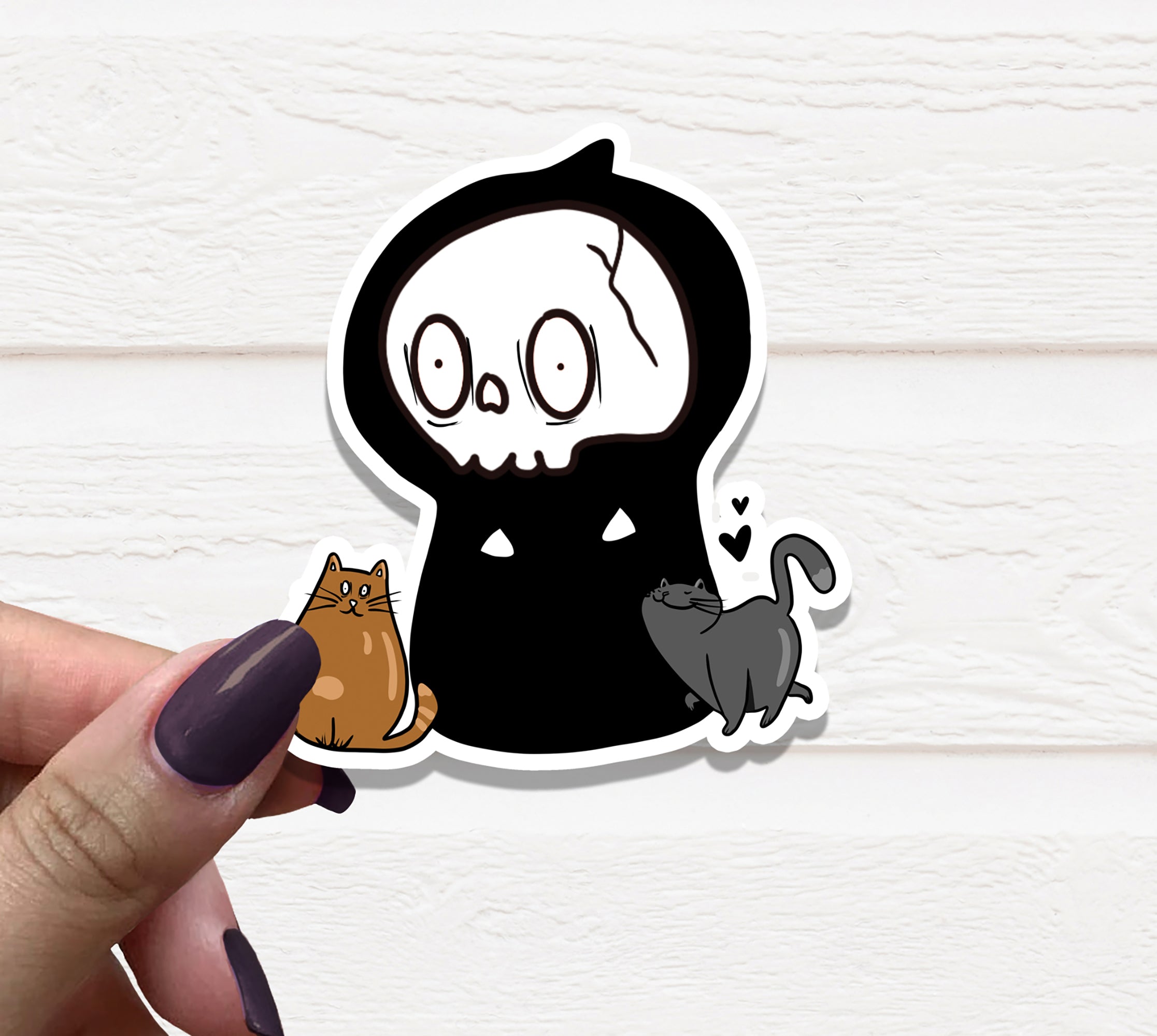 Cats and Grim Reaper Vinyl Sticker featuring a whimsical design of cats alongside a Grim Reaper figure, printed on high-quality matte vinyl.