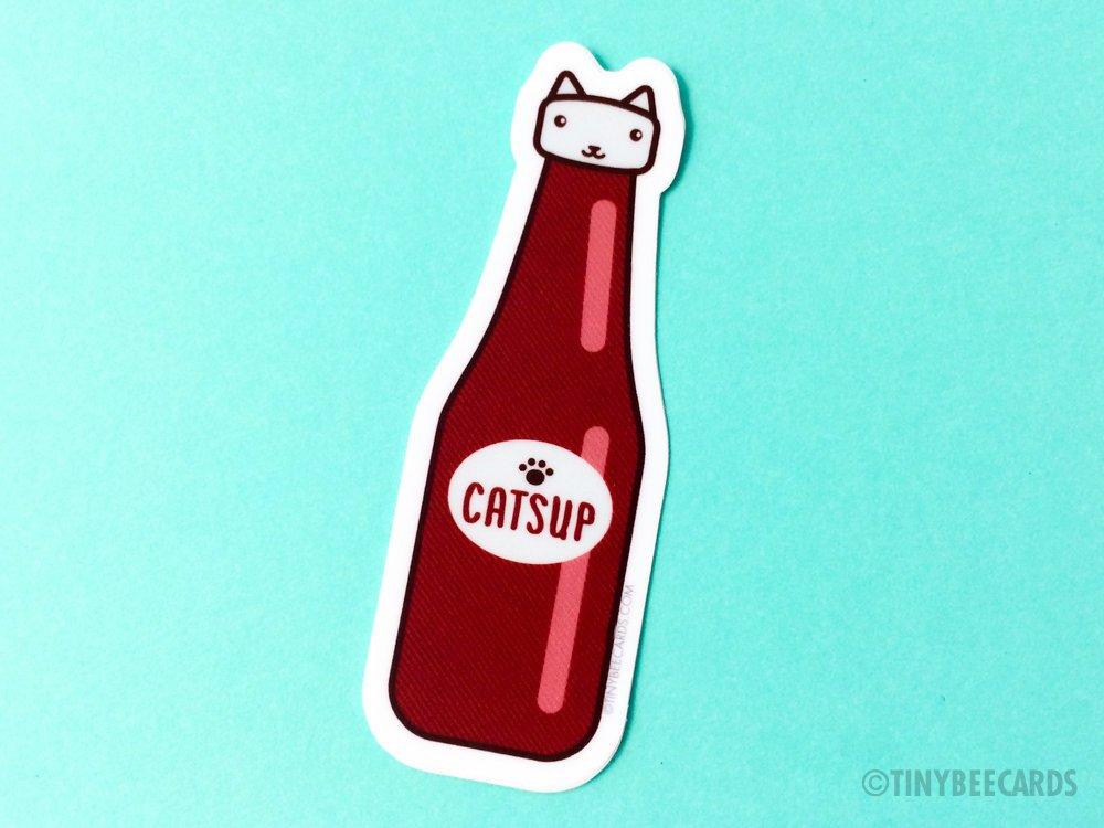 Catsup Cat vinyl sticker featuring a humorous cat design with the text 'Catsup', perfect for personalizing items.