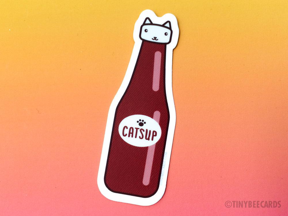 Catsup Cat vinyl sticker featuring a humorous cat design with the text 'Catsup', perfect for personalizing items.