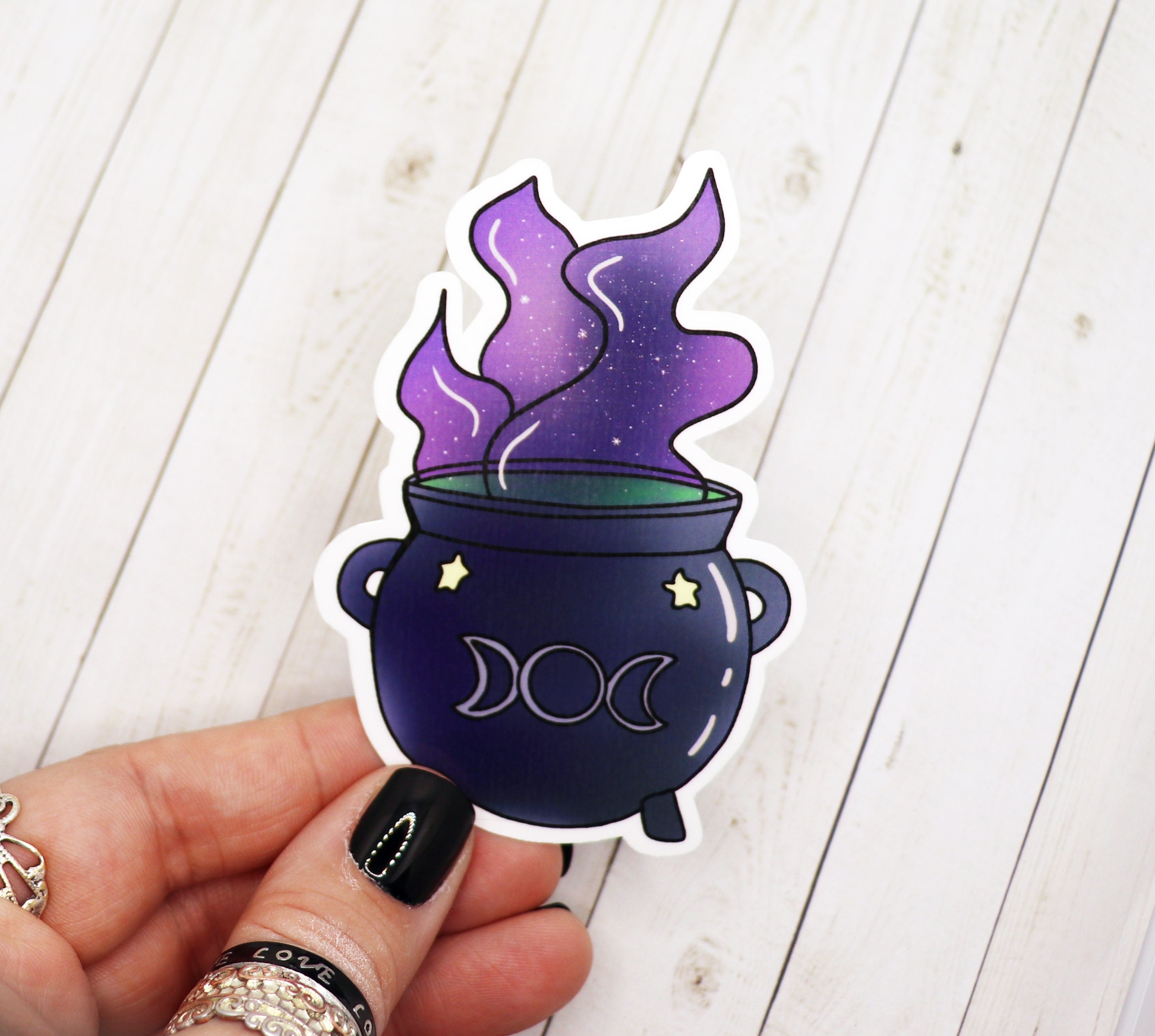 A vibrant cauldron sticker featuring a magical design, perfect for personalizing various items.