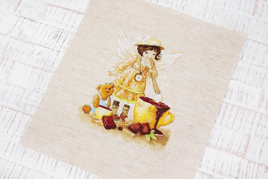 Chocolate Fairy B1131L Counted Cross-Stitch Kit featuring a fairy with hot chocolate and teddy bear on rustic canvas.