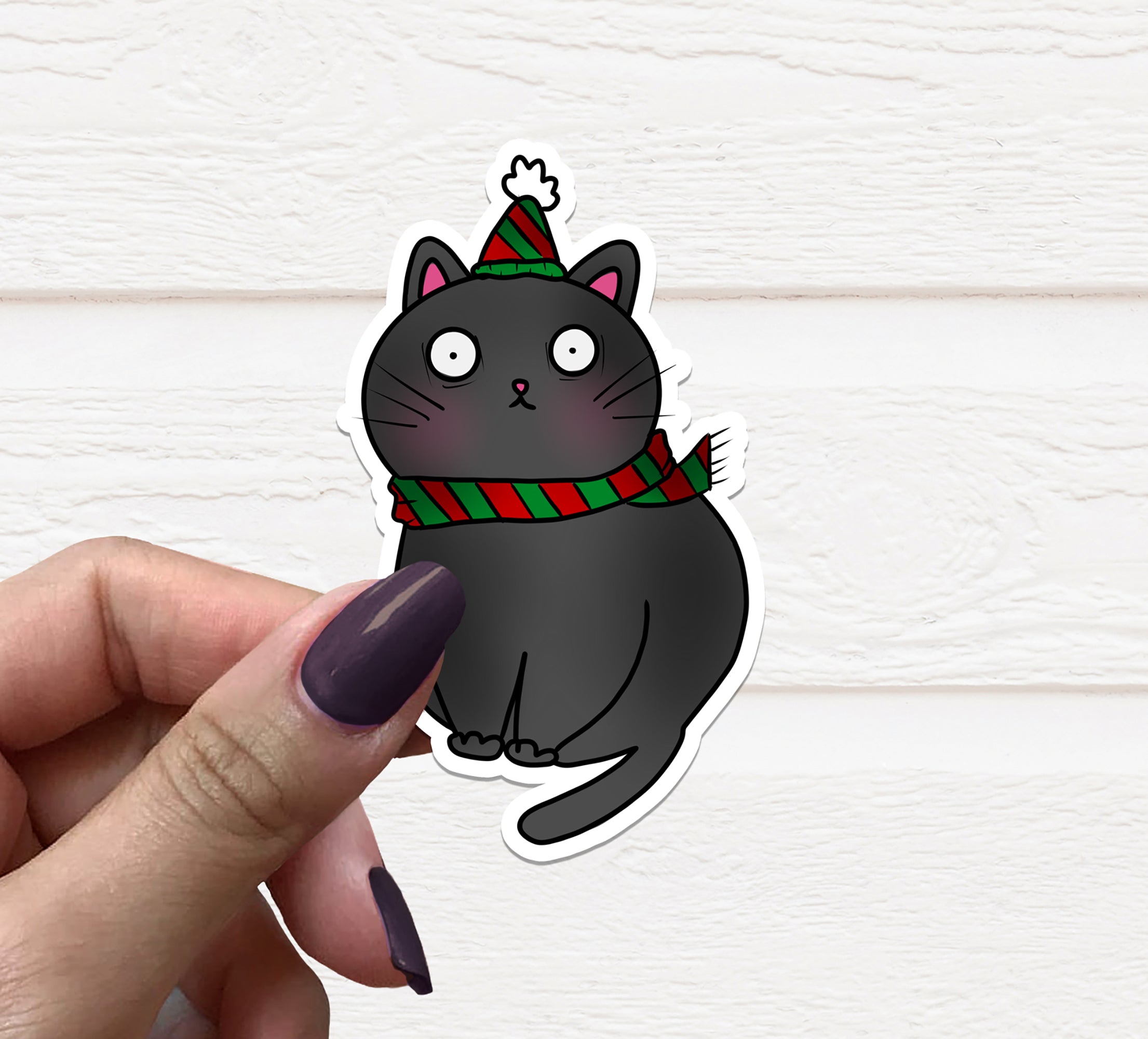 A cute Christmas Cat Vinyl Sticker featuring a festive cat design, perfect for decorating various items.