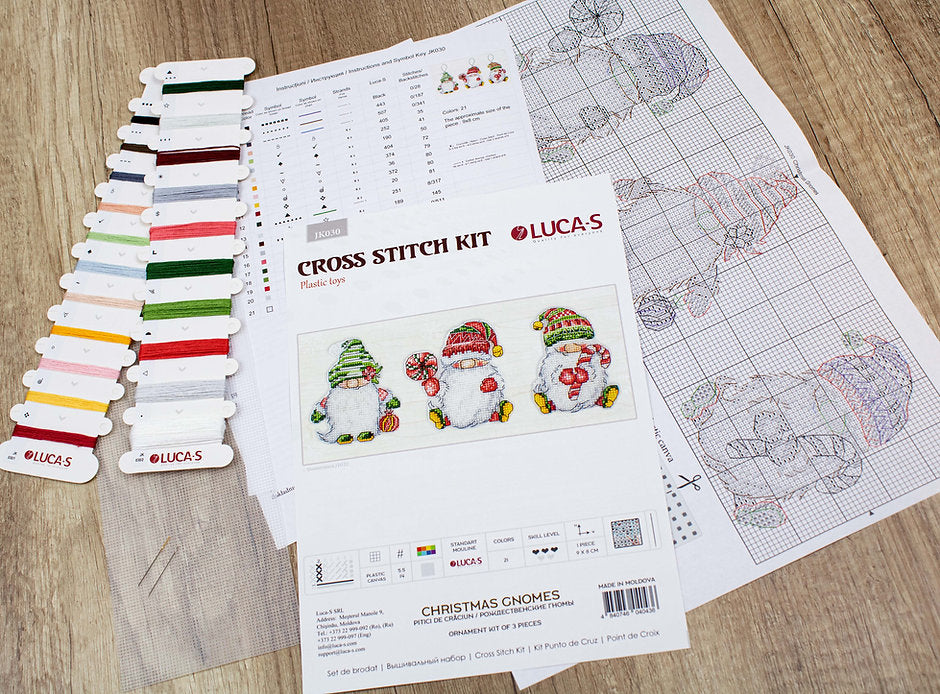 Christmas Gnomes JK030L Counted Cross-Stitch Kit featuring colorful threads, Aida canvas, and needle for festive crafting.