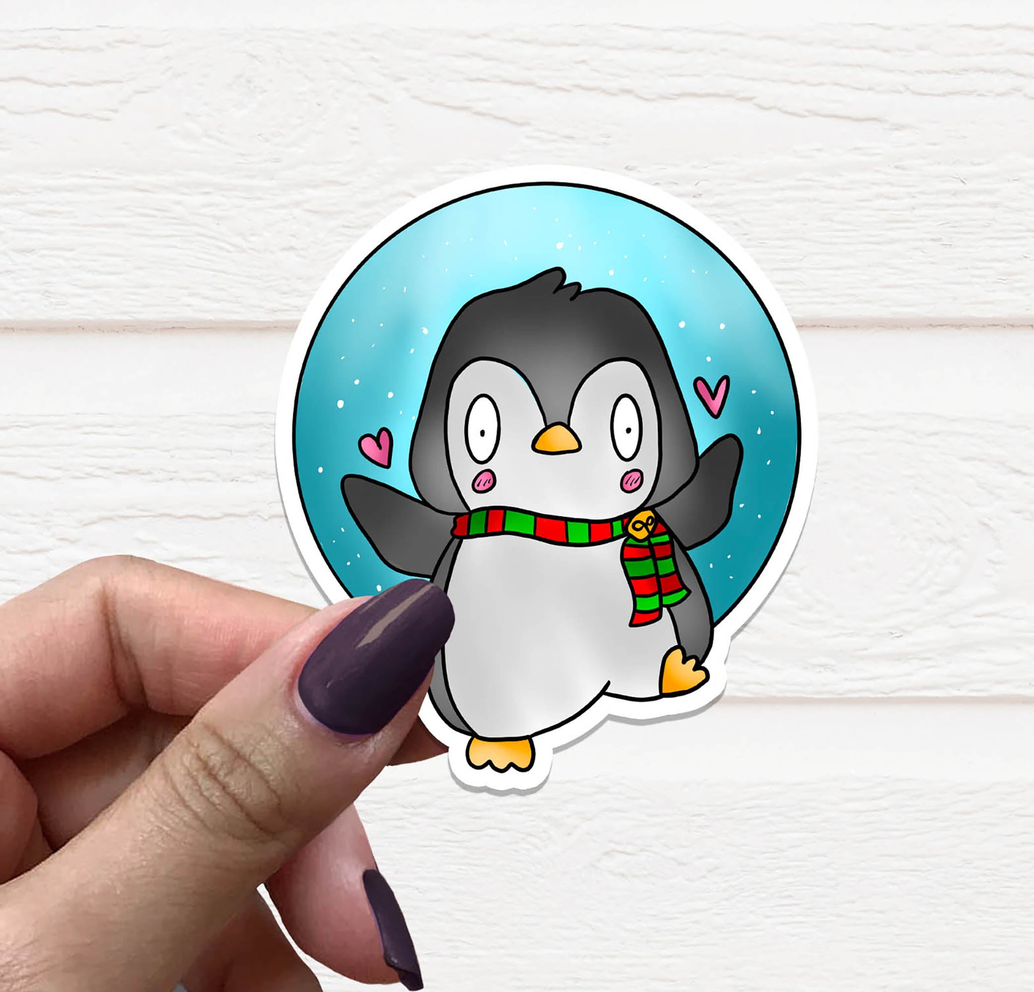 A cute Christmas Penguin Vinyl Sticker featuring a festive penguin design, perfect for holiday decorations.