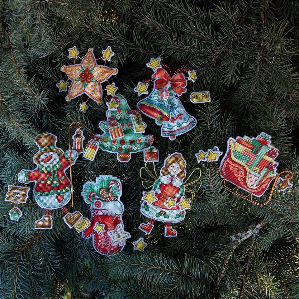 Colorful Christmas tree toy cross-stitch kit with plastic canvas, cotton floss, and felt materials.