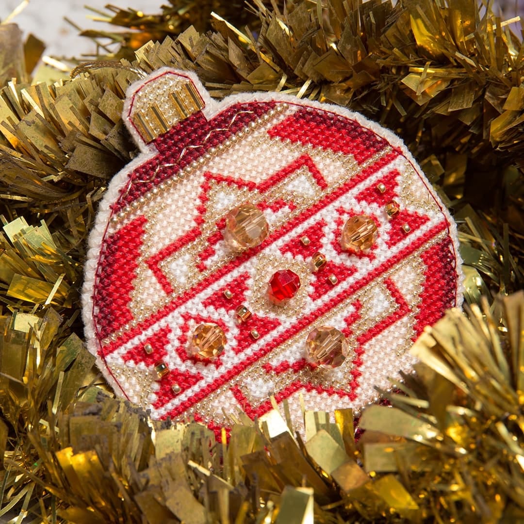 Colorful Christmas tree toy cross-stitch kit with beads and floss, perfect for holiday crafting.