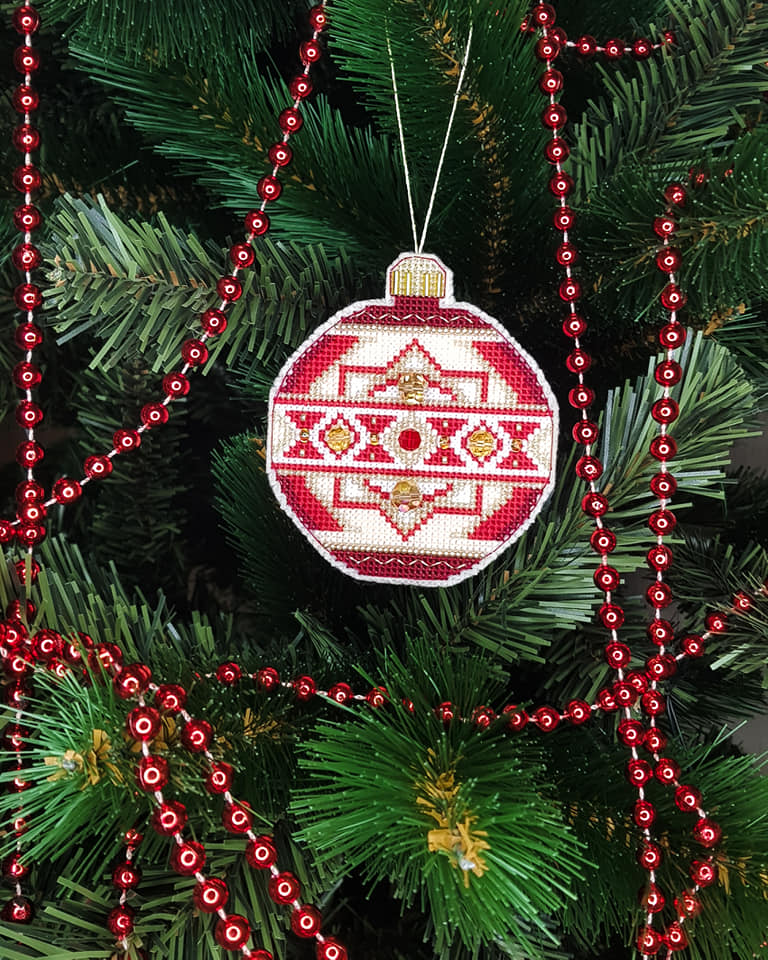 Colorful Christmas tree toy cross-stitch kit with beads and floss, perfect for holiday crafting.