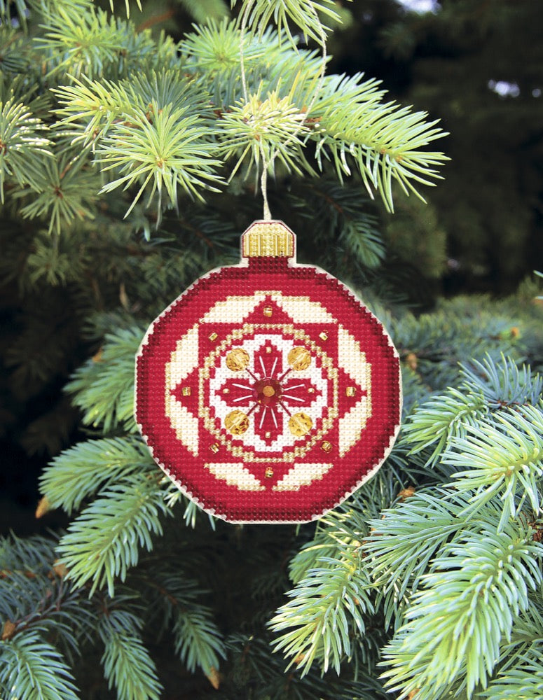 Colorful Christmas tree toy plastic canvas cross-stitch kit with beads and floss, showcasing festive crafting materials.