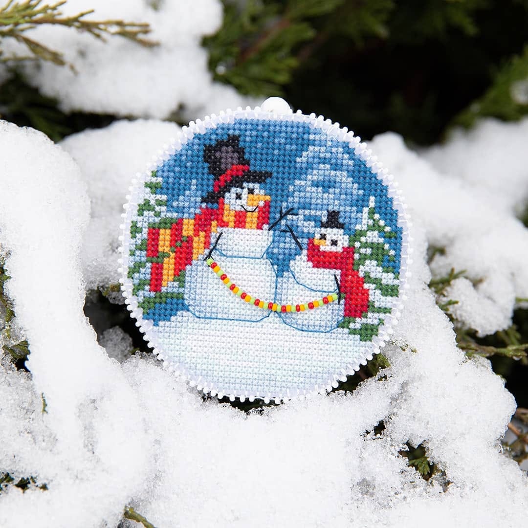 Christmas tree toy plastic canvas cross-stitch kit with colorful threads and beads, perfect for holiday crafting.