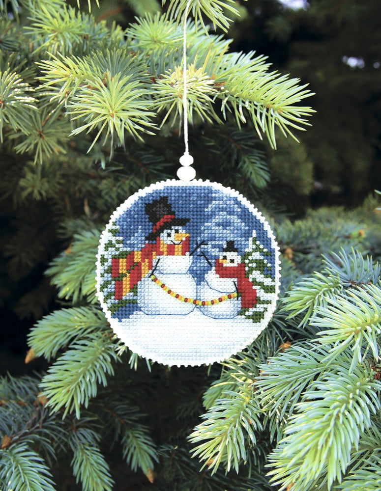 Christmas tree toy plastic canvas cross-stitch kit with colorful threads and beads, perfect for holiday crafting.