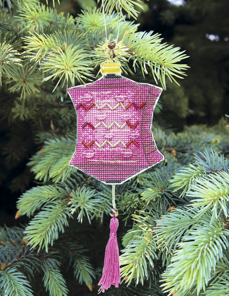 Colorful Christmas tree toy cross-stitch kit with vibrant materials including plastic canvas, cotton floss, and beads.