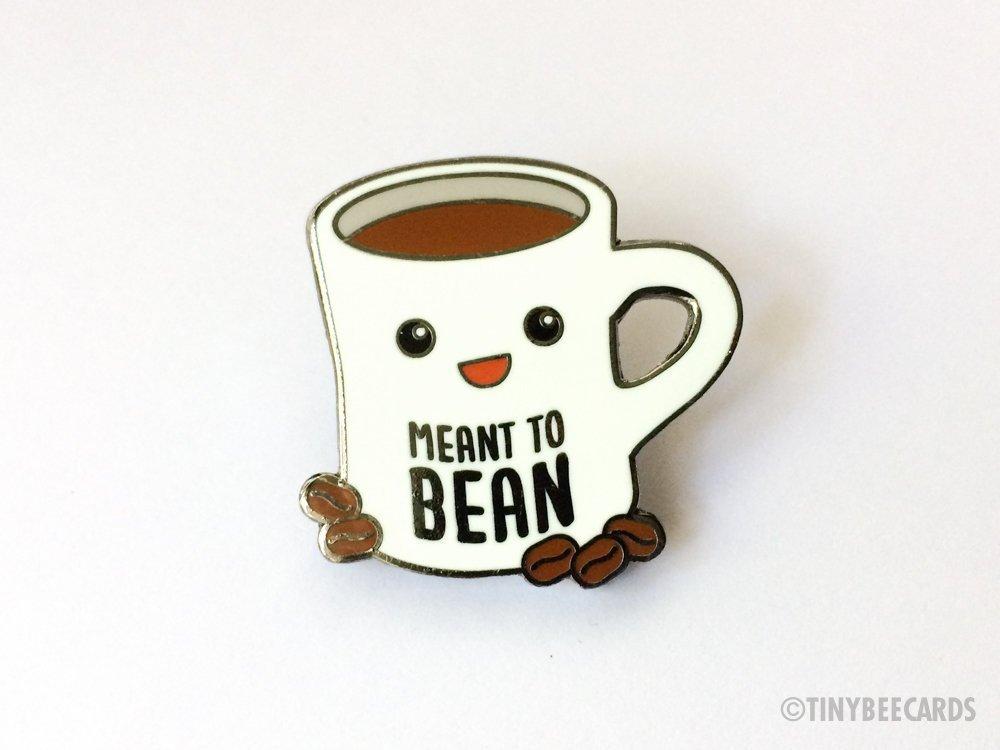 Cute hard enamel pin featuring kawaii coffee cup and coffee beans with pun text 'meant to bean'.