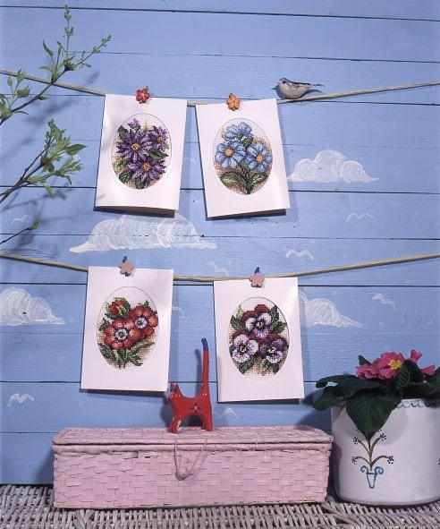 Complete cross stitch kit featuring pansies design, includes fabric, threads, card, envelope, and needle.