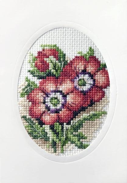 Complete cross stitch kit featuring red flowers, including Zweigart aida, DMC threads, blank card, and envelope.