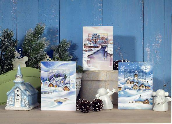 Complete cross stitch kit featuring a winter landscape design, including Zweigart aida fabric, DMC threads, embellished card, and instructions.