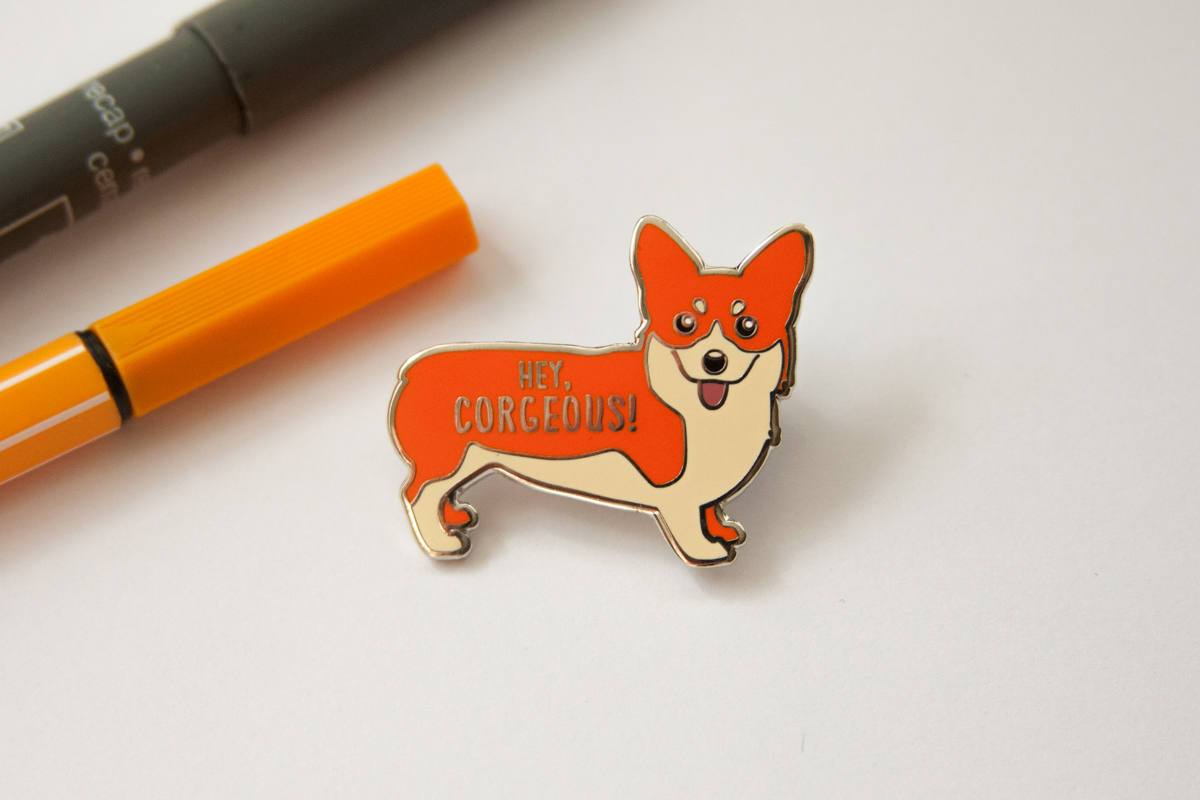 Corgi Hard Enamel Pin featuring a cute corgi design with the text 'Hey Corgeous!' on a silver metal background.