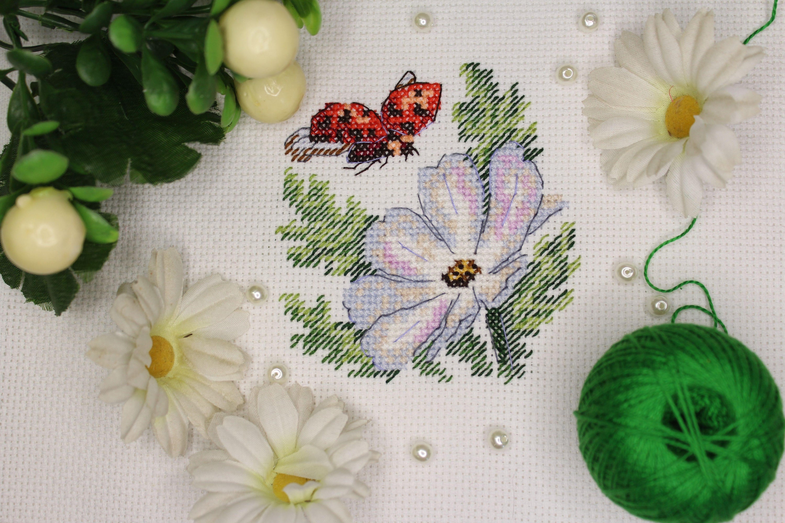 Cosmos SM-617 Counted Cross Stitch Kit featuring Aida canvas, colorful threads, and needle for crafting.