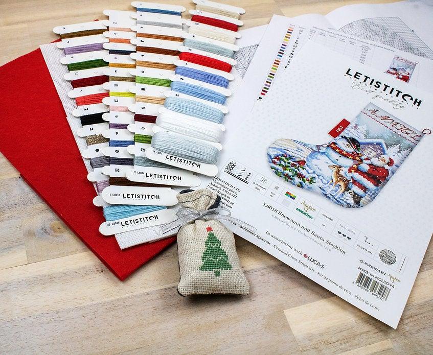 Counted Cross Stitch Kit featuring a Snowman and Santa design, includes colorful threads and canvas.