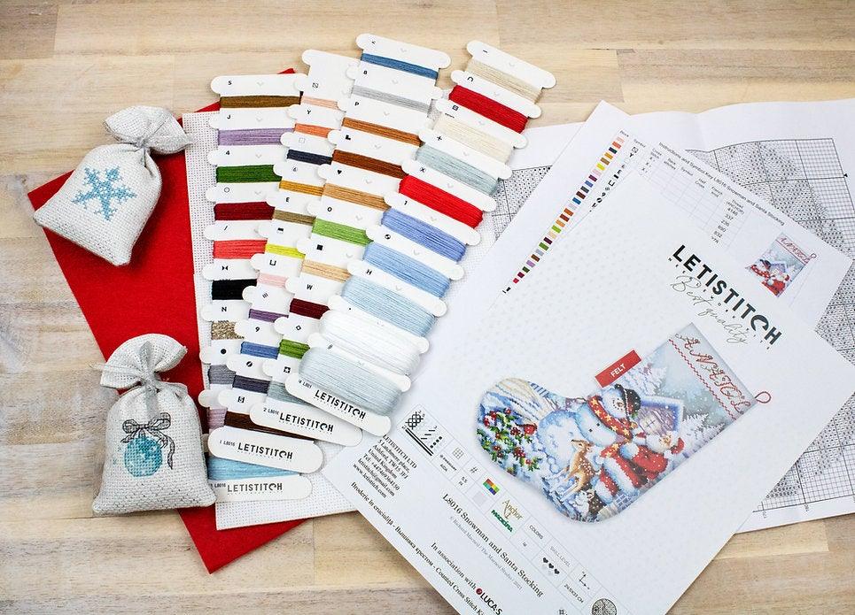 Counted Cross Stitch Kit featuring a Snowman and Santa design, includes colorful threads and canvas.