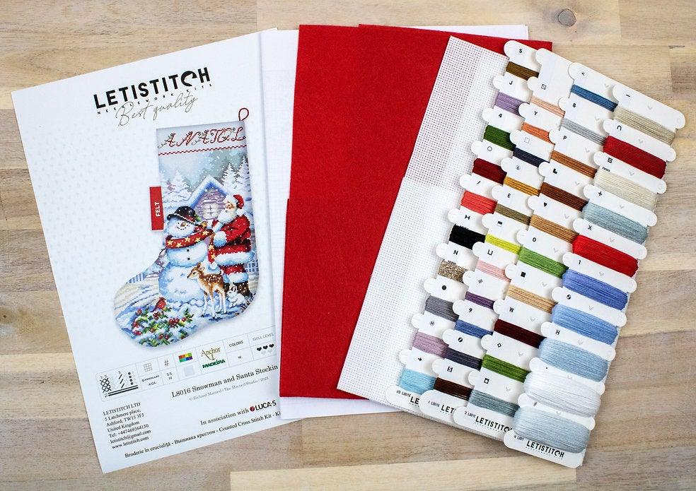 Counted Cross Stitch Kit featuring a Snowman and Santa design, includes colorful threads and canvas.