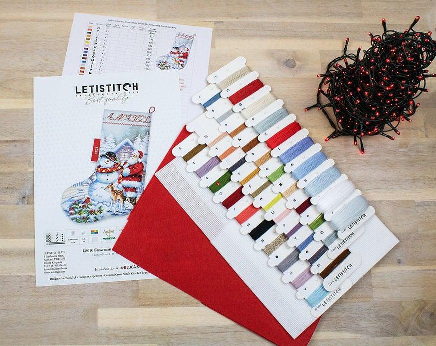 Counted Cross Stitch Kit featuring a Snowman and Santa design, includes colorful threads and canvas.