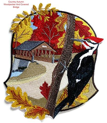 Embroidered patch featuring a woodpecker and a covered bridge, showcasing autumn colors and intricate details.