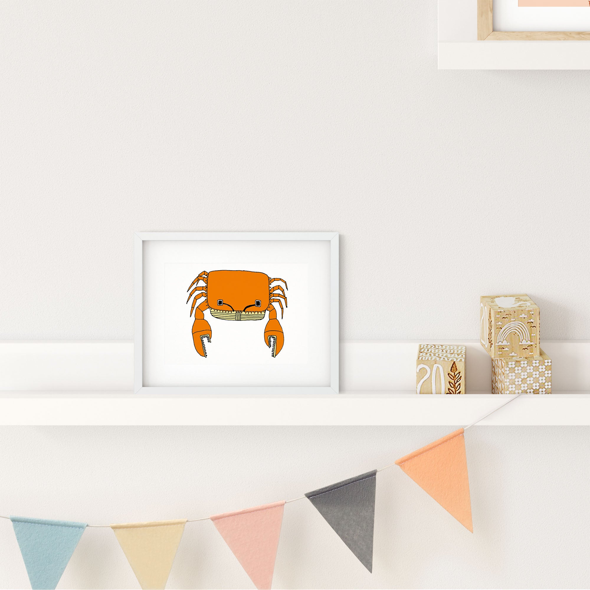 A colorful illustrated print of a crab with antenna-like eyes, showcasing playful design elements.