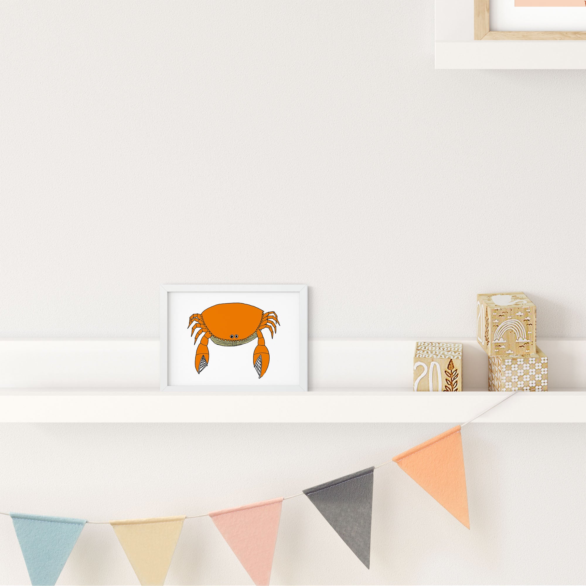 A colorful illustrated print of a round crab, showcasing playful design and vibrant colors.