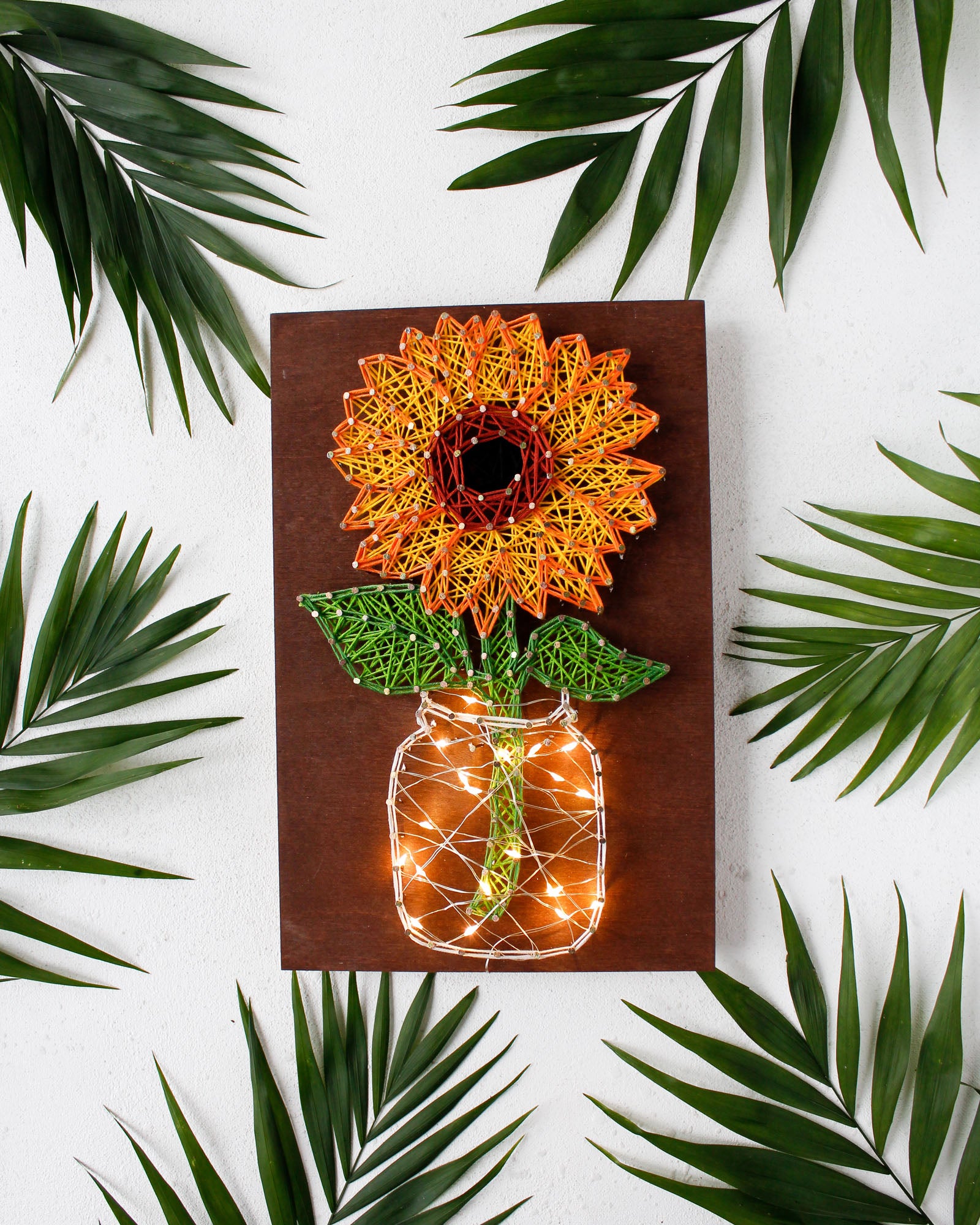 Creative Kit/String Art Sunflower ABC-018 with wooden base, colorful threads, and nails for crafting.