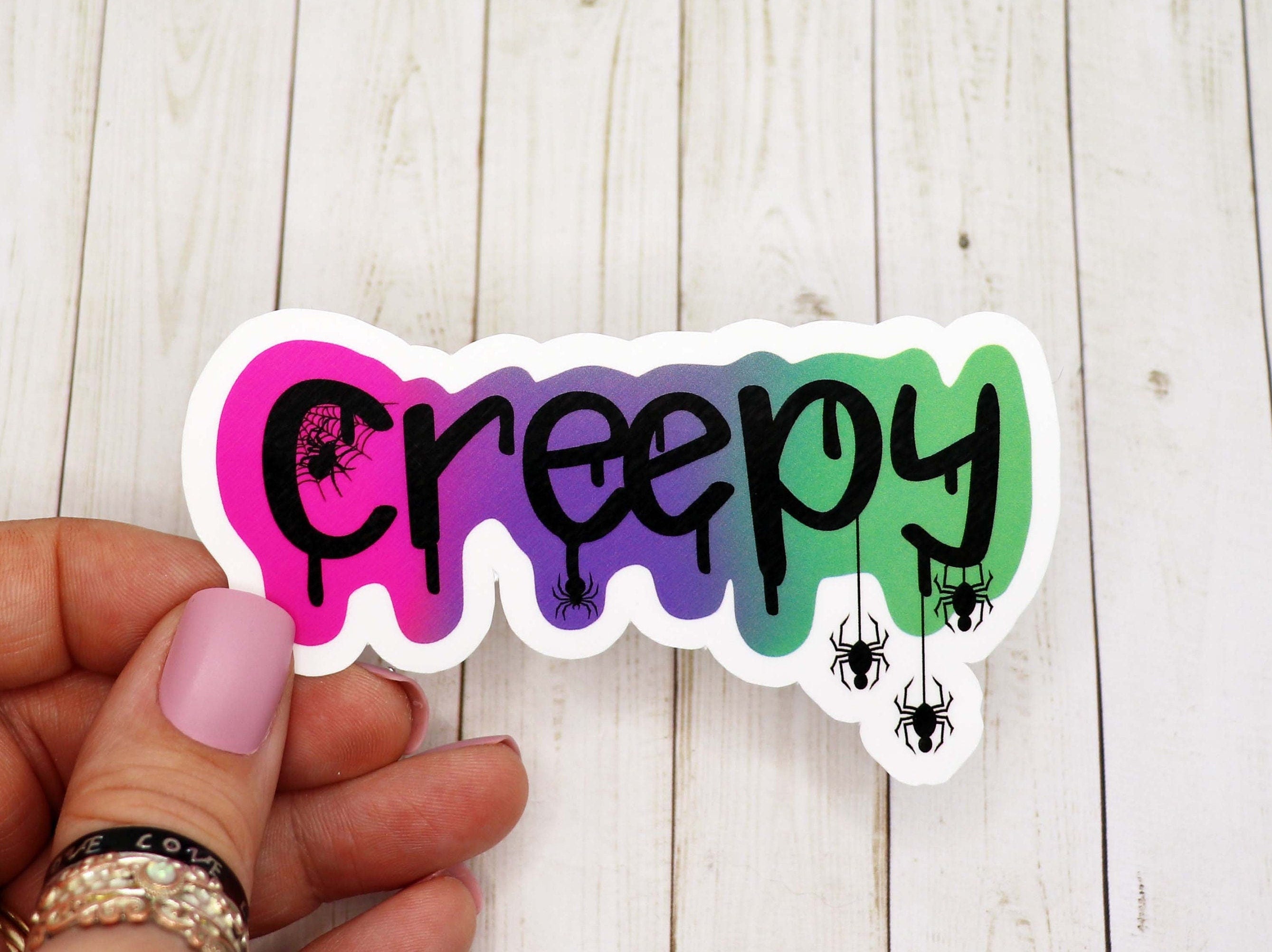 A spooky 3-inch creepy vinyl sticker featuring a unique design, perfect for personalizing various items.