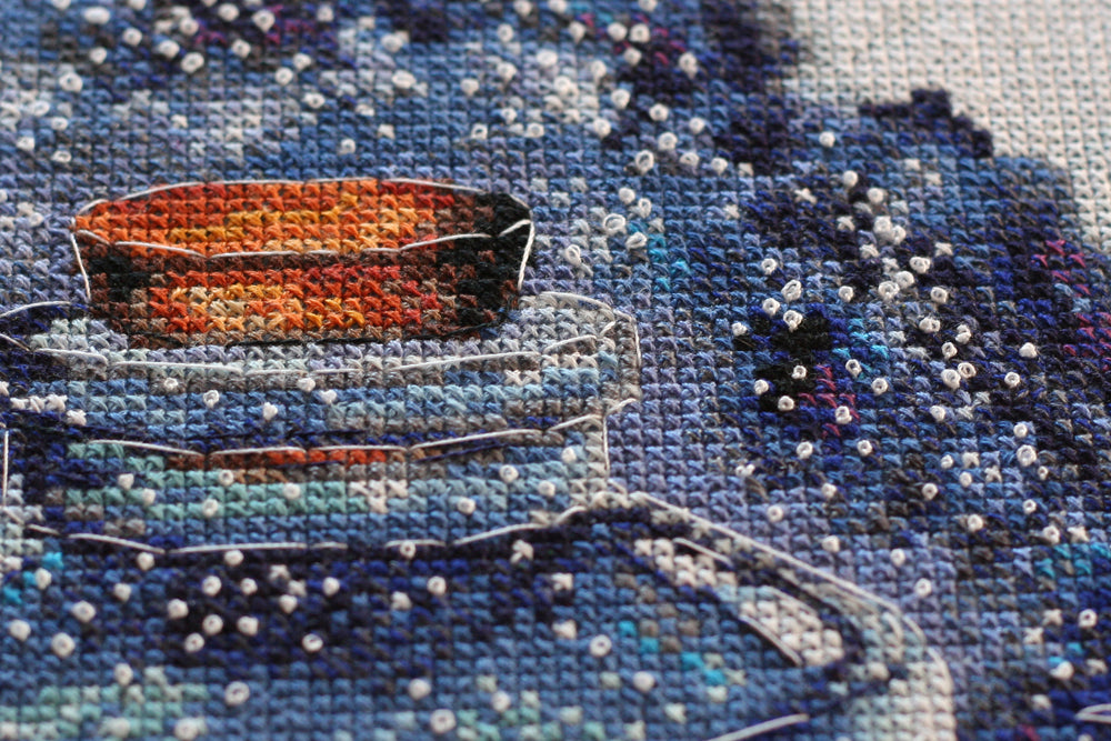 Cross-stitch kit A month for lovers AH-095 featuring dark blue canvas, colorful floss, and stitching supplies.