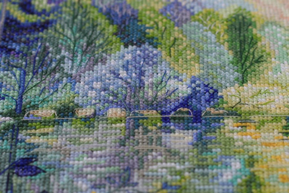 Cross-stitch kit Dawn over the river AH-152 featuring cotton canvas, colorful floss, and stitching supplies.