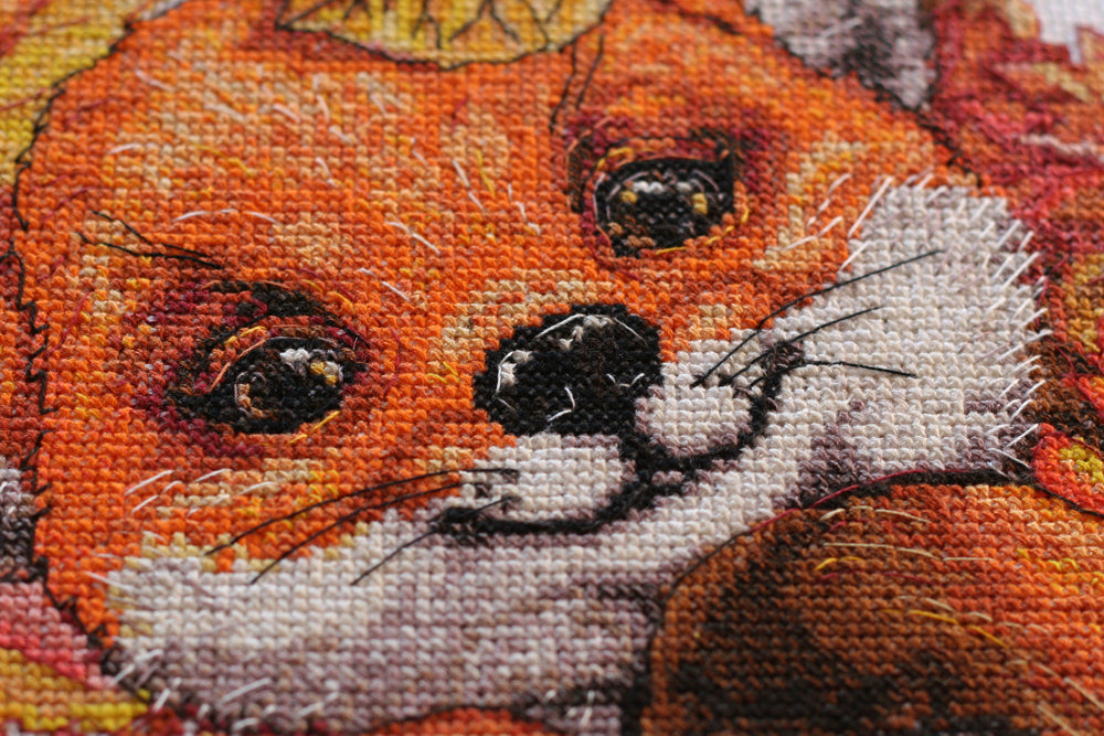 Cross-stitch kit First autumn AH-112 featuring cotton canvas, colorful floss, and needles for crafting autumn-themed art.