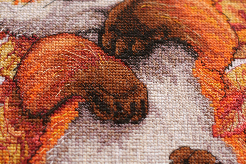 Cross-stitch kit First autumn AH-112 featuring cotton canvas, colorful floss, and needles for crafting autumn-themed art.