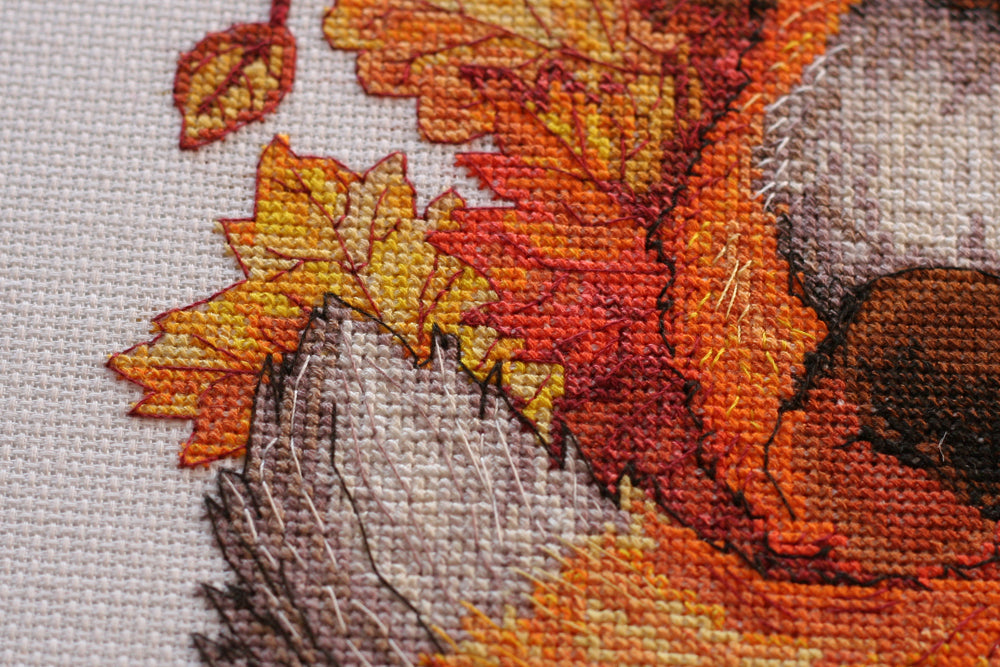 Cross-stitch kit First autumn AH-112 featuring cotton canvas, colorful floss, and needles for crafting autumn-themed art.